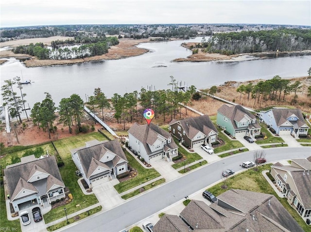 drone / aerial view featuring a residential view and a water view