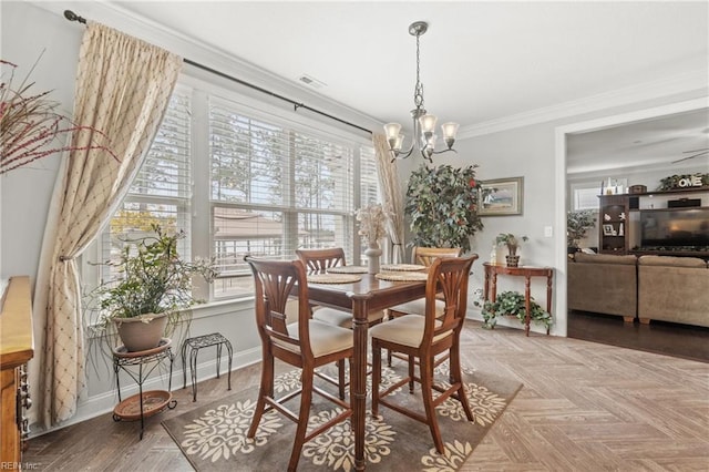 dining room with a chandelier, visible vents, baseboards, and ornamental molding