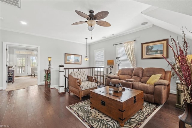 living area featuring visible vents, wood-type flooring, a healthy amount of sunlight, and crown molding