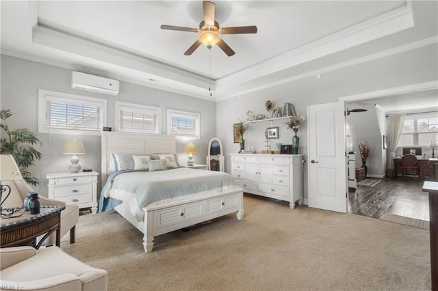 bedroom featuring light carpet, a wall mounted AC, a raised ceiling, and crown molding