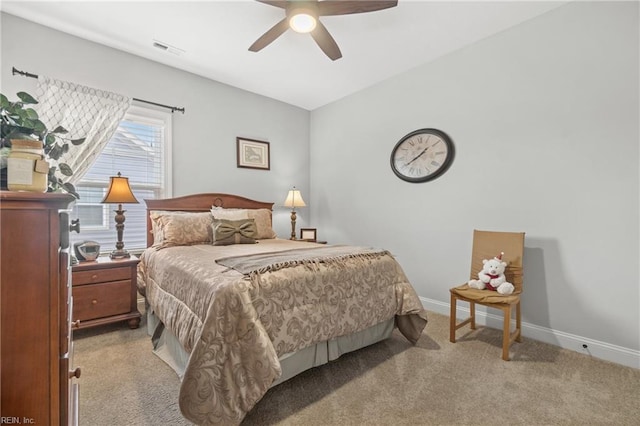 bedroom featuring a ceiling fan, visible vents, baseboards, and carpet floors