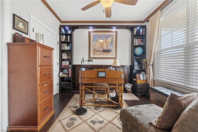 home office featuring wood finished floors, a ceiling fan, and ornamental molding