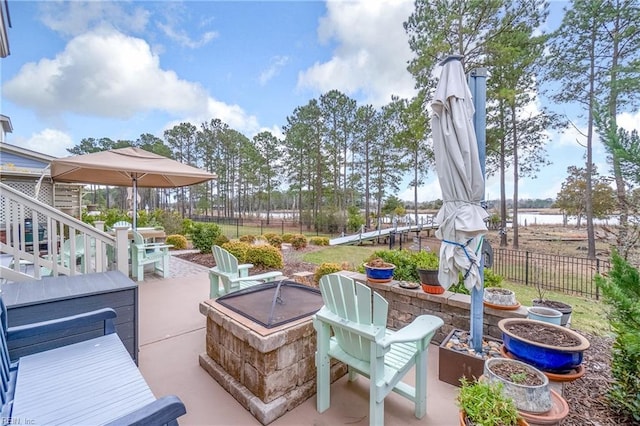 view of patio with a fire pit and fence