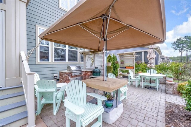 view of patio with area for grilling, outdoor dining area, and a grill