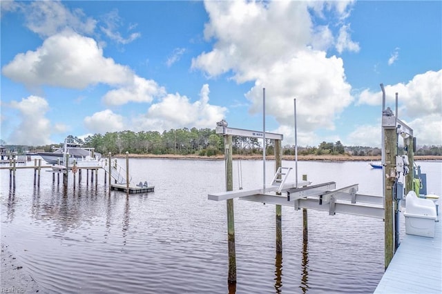 dock area with a water view and boat lift