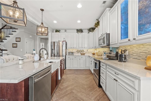 kitchen featuring recessed lighting, stainless steel appliances, backsplash, and white cabinets