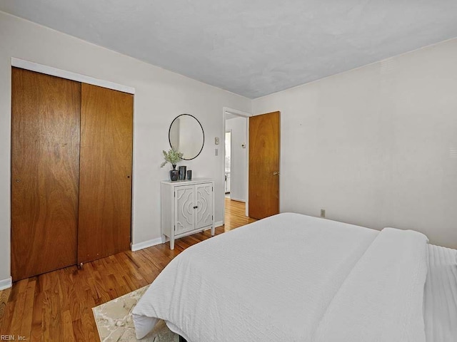 bedroom with a closet and wood finished floors