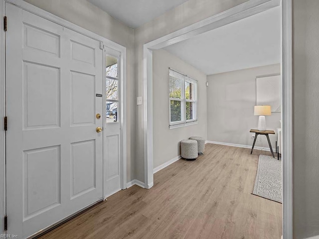 entrance foyer featuring baseboards and light wood finished floors