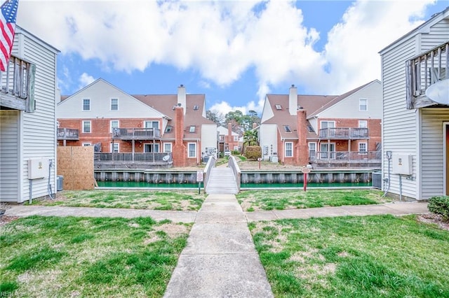 surrounding community with a yard and a residential view