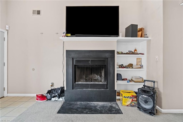 interior details featuring visible vents, a fireplace with flush hearth, and baseboards