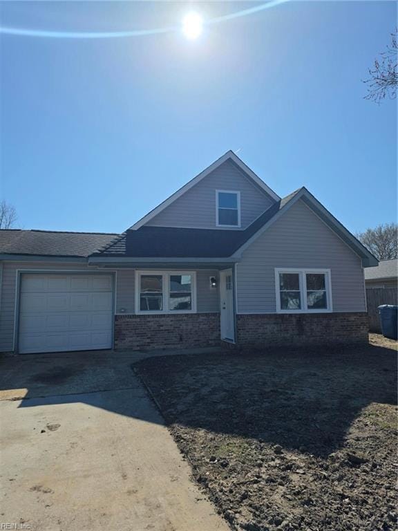 view of front of home featuring concrete driveway and an attached garage