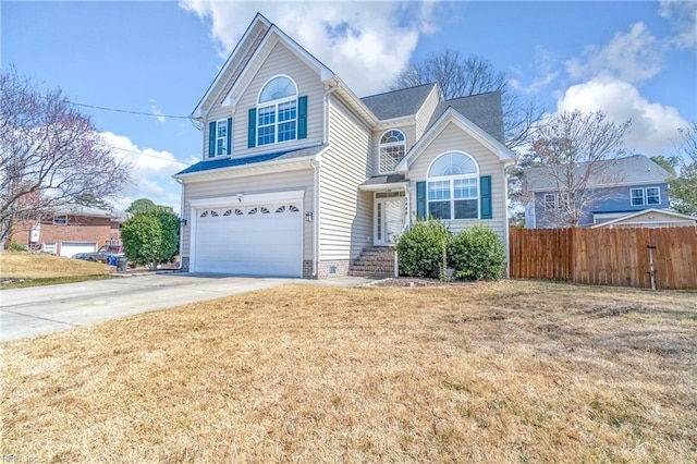 traditional-style house with concrete driveway, an attached garage, fence, and a front lawn