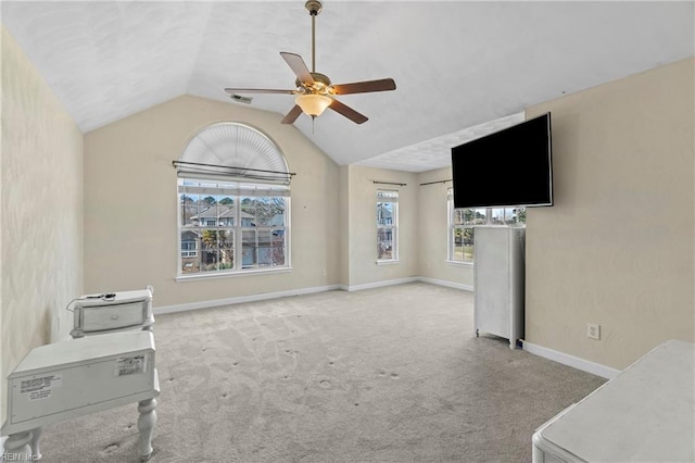 living area with visible vents, baseboards, vaulted ceiling, carpet floors, and a ceiling fan