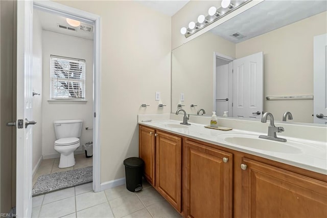 bathroom with a sink, visible vents, toilet, and tile patterned flooring