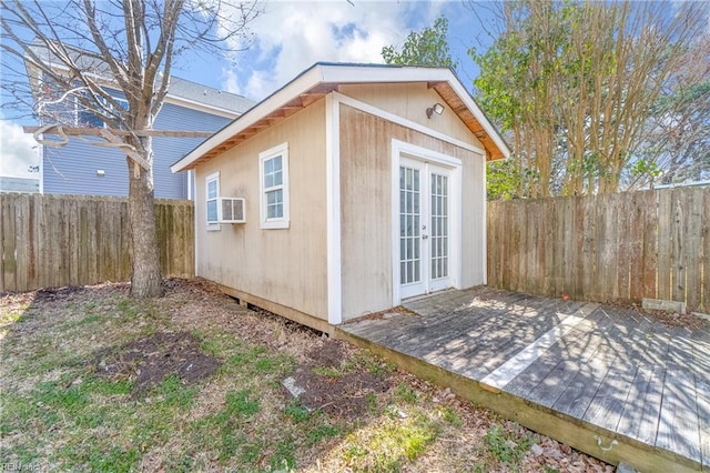 view of outdoor structure featuring french doors, an outdoor structure, and a fenced backyard