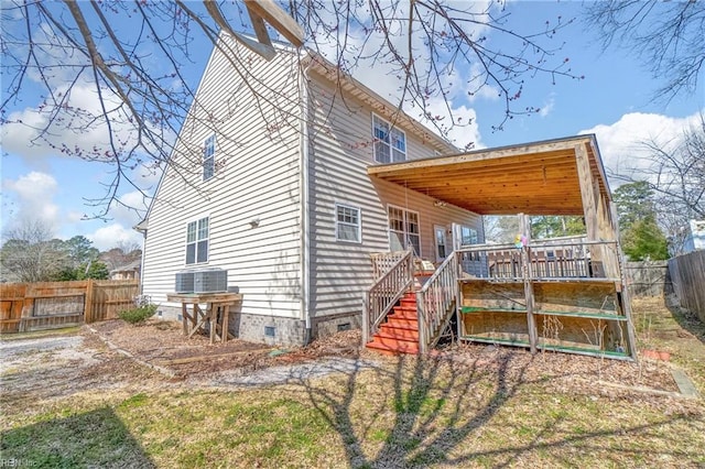 view of side of property with crawl space, stairway, cooling unit, and a fenced backyard