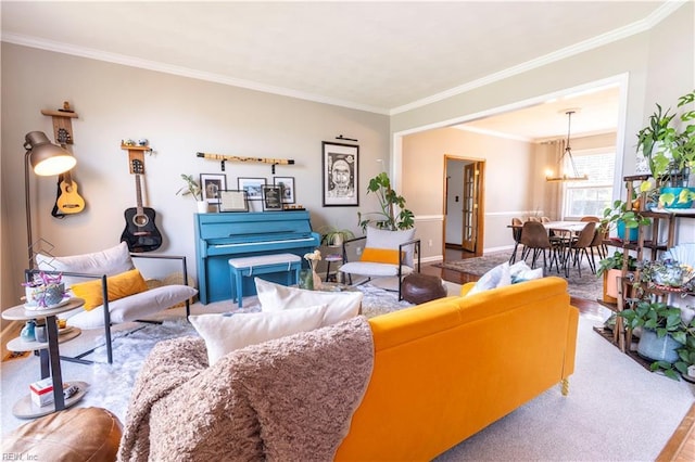 living room featuring baseboards, a chandelier, and ornamental molding