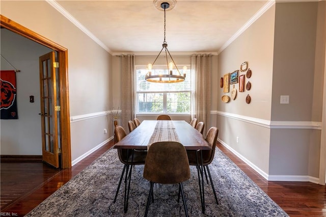 dining room with an inviting chandelier, ornamental molding, and dark wood-style flooring