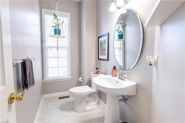 bathroom with tile patterned flooring, visible vents, toilet, and baseboards