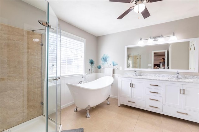 full bathroom with a sink, a freestanding tub, a stall shower, and double vanity