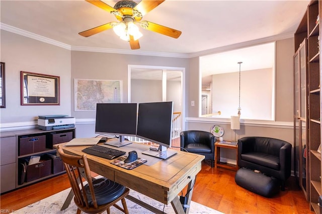 office area with ornamental molding, a ceiling fan, and wood finished floors