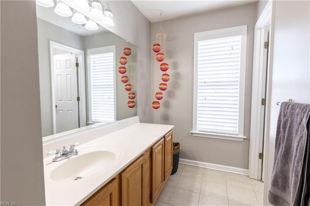 bathroom featuring baseboards, vanity, and tile patterned flooring