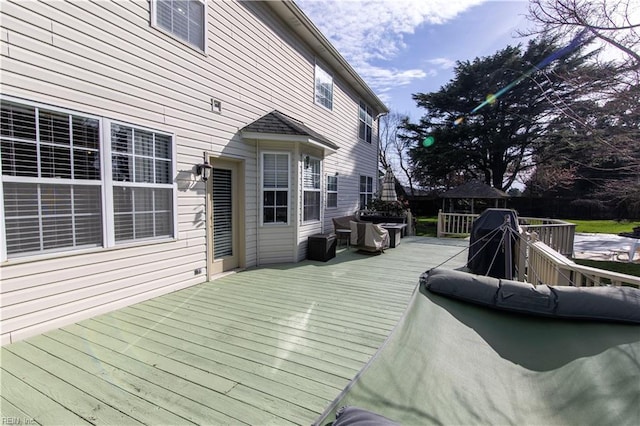 wooden terrace featuring area for grilling