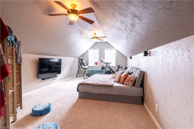 bedroom featuring lofted ceiling, carpet, a ceiling fan, and a textured ceiling