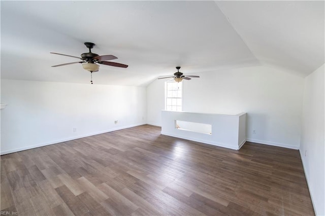 unfurnished living room featuring baseboards, lofted ceiling, and wood finished floors