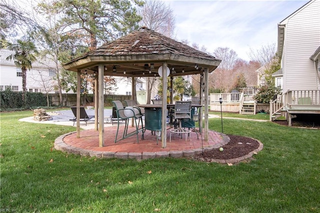 view of yard with a deck, a gazebo, fence, and a patio