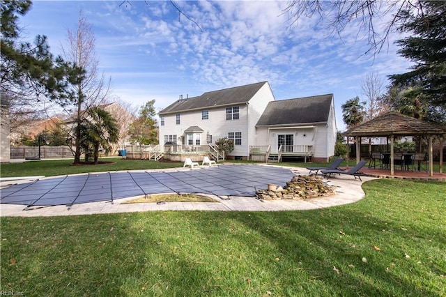 view of pool with a gazebo, a fenced in pool, a wooden deck, and a yard