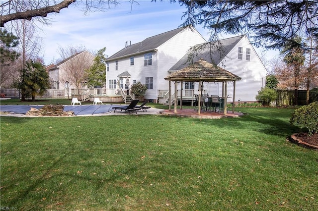 back of house featuring a gazebo, a yard, fence, and a patio