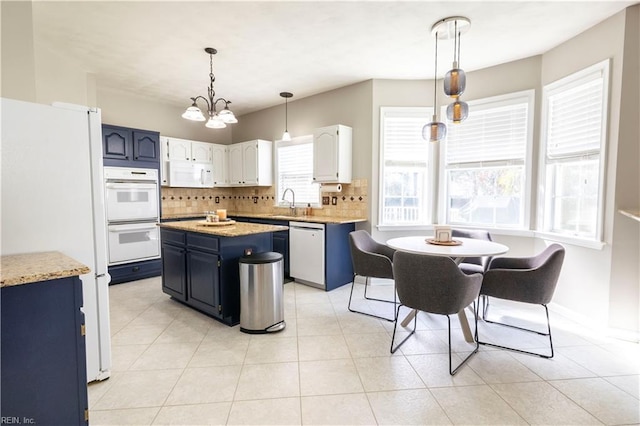 kitchen featuring decorative backsplash, white appliances, light tile patterned flooring, and hanging light fixtures