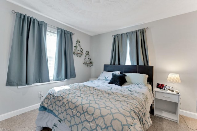 carpeted bedroom featuring baseboards