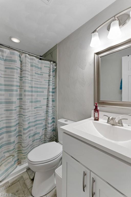 full bathroom with vanity, toilet, and a shower with curtain