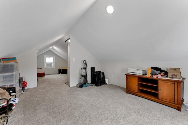 additional living space featuring carpet floors and vaulted ceiling