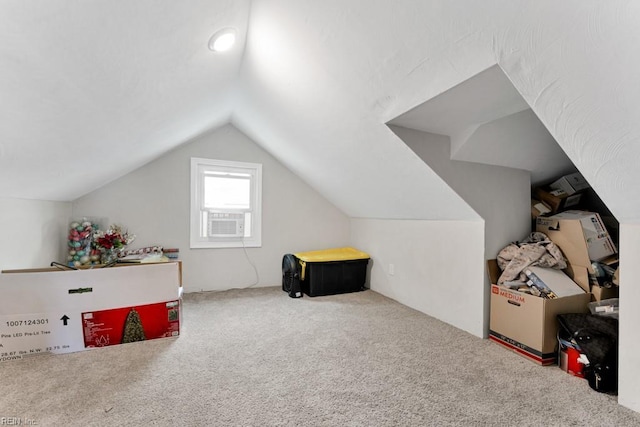 additional living space featuring cooling unit, lofted ceiling, and carpet floors