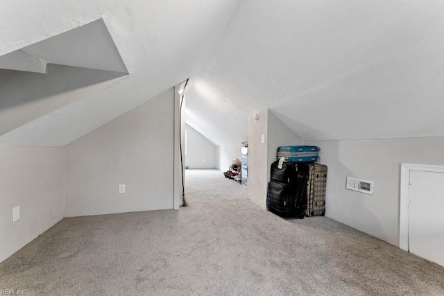 additional living space with lofted ceiling and carpet