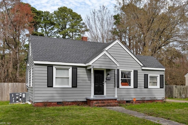 bungalow-style house featuring fence, roof with shingles, and crawl space