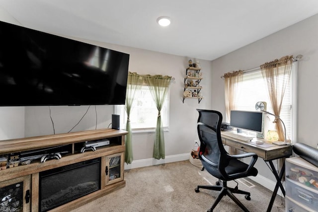 office with light colored carpet, baseboards, and a wealth of natural light