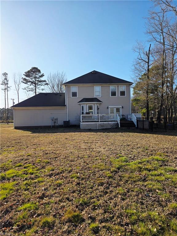 back of house with a lawn and a wooden deck