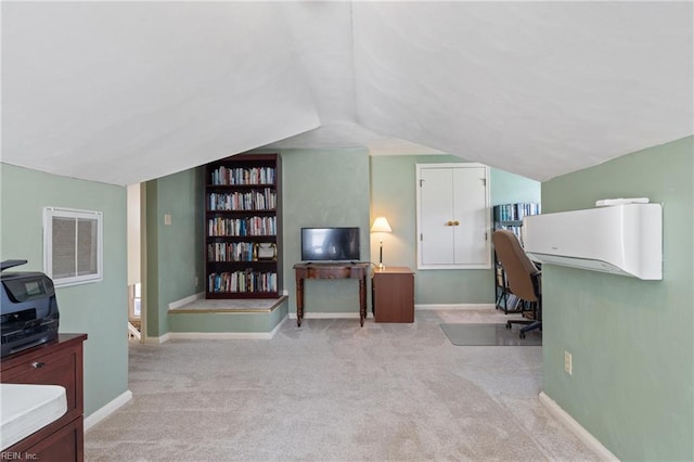 carpeted office with built in features, baseboards, and lofted ceiling