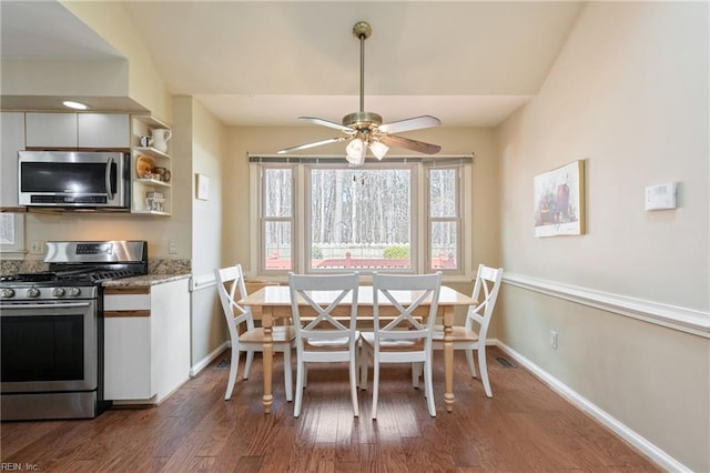 dining room with dark wood-style floors, baseboards, and ceiling fan