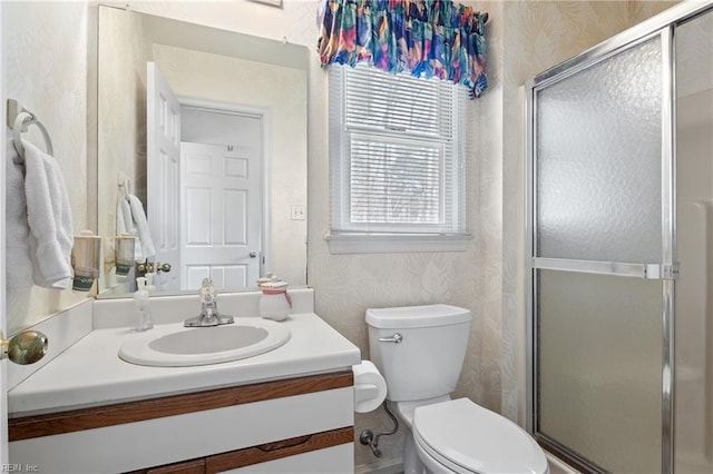 full bathroom with wallpapered walls, vanity, and a stall shower