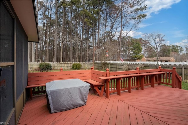 wooden deck featuring a fenced backyard