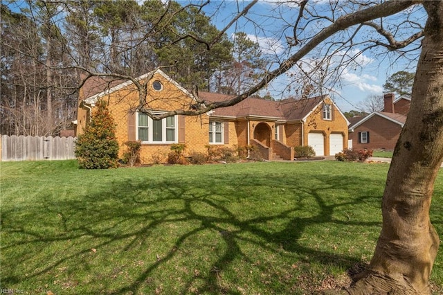 view of front facade featuring a garage, brick siding, a front lawn, and fence