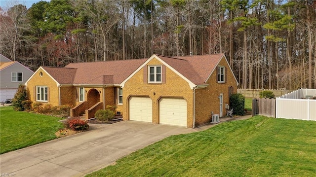 view of front facade featuring driveway, brick siding, a front yard, and fence