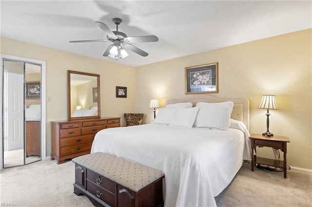 bedroom featuring baseboards, light carpet, and ceiling fan