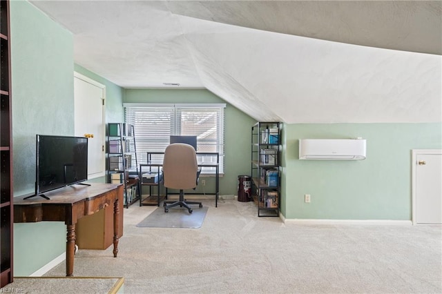 carpeted office space with baseboards, a wall mounted air conditioner, and lofted ceiling