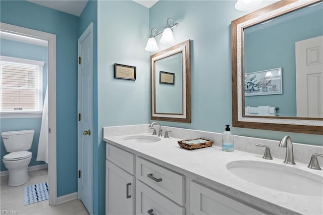 full bathroom with tile patterned floors, toilet, double vanity, and a sink